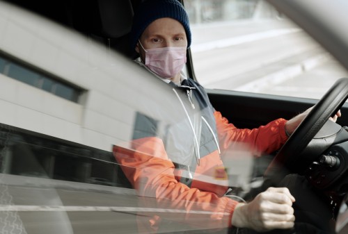 Man using car with COVID-19 protocols